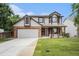Charming two-story home features a well-manicured lawn, brick accents, and an attached two-car garage at 17548 E Wesley Pl, Aurora, CO 80013