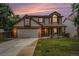 Charming two-story home boasts a well-manicured lawn, brick accents, and an attached two-car garage at 17548 E Wesley Pl, Aurora, CO 80013