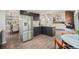 Open kitchen layout featuring dark cabinets, stainless steel appliances, and a breakfast bar at 17548 E Wesley Pl, Aurora, CO 80013
