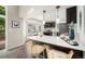 Bright, modern kitchen features a breakfast bar, stainless appliances, and sleek countertops at 17548 E Wesley Pl, Aurora, CO 80013
