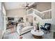 Open concept living room showcases vaulted ceilings, staircase, hardwood floors, and access to kitchen at 17548 E Wesley Pl, Aurora, CO 80013