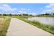 Scenic walking path alongside a serene pond in the community at 17548 E Wesley Pl, Aurora, CO 80013