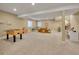 Spacious finished basement with neutral carpeting, lots of room for activities and an area that could be used as an office at 668 E Dry Creek Cir, Littleton, CO 80122