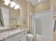 Bright bathroom featuring a shower/tub with a light blue shower curtain, and a vanity with a granite countertop at 668 E Dry Creek Cir, Littleton, CO 80122