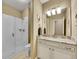 Bright bathroom featuring a large glass enclosed shower, a vanity with a granite countertop, and soft neutral wall paint at 668 E Dry Creek Cir, Littleton, CO 80122