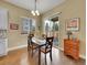Cozy dining area with sliding doors to the backyard, hardwood floors, and natural light at 668 E Dry Creek Cir, Littleton, CO 80122