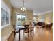 Inviting dining area with hardwood floors, a sliding glass door to the backyard, and seamless access to the living room at 668 E Dry Creek Cir, Littleton, CO 80122