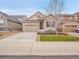 Inviting two-story home with a well-maintained front yard, attached two-car garage, and classic curb appeal at 668 E Dry Creek Cir, Littleton, CO 80122
