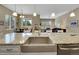 Bright kitchen features an open layout to the living areas, stainless steel appliances, and breakfast bar seating at 668 E Dry Creek Cir, Littleton, CO 80122
