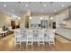 Spacious kitchen with white cabinetry, granite countertops, and large island with seating at 668 E Dry Creek Cir, Littleton, CO 80122