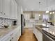 Modern kitchen showcasing granite countertops, stainless appliances, and a large island with seating at 668 E Dry Creek Cir, Littleton, CO 80122