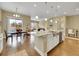 Bright, open kitchen features stainless steel appliances, hardwood floors, and eat-in dining area at 668 E Dry Creek Cir, Littleton, CO 80122