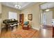 Elegant living room featuring a piano, comfortable seating, hardwood floors, and plenty of natural light at 668 E Dry Creek Cir, Littleton, CO 80122