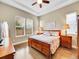 Cozy main bedroom with hardwood floors, large windows, and a tray ceiling offers a peaceful retreat at 668 E Dry Creek Cir, Littleton, CO 80122
