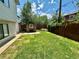 Green backyard featuring a stone oven and surrounding privacy fence with room for activities at 45 Pierce St, Lakewood, CO 80226