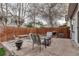 Backyard stone patio with outdoor furniture and a wooden fence, perfect for entertaining at 45 Pierce St, Lakewood, CO 80226