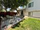 Charming backyard featuring a stone patio, garden, dining set, and privacy fence at 45 Pierce St, Lakewood, CO 80226