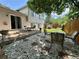 Inviting backyard with patio, garden, stone accents, outdoor dining set, and partial shade coverage at 45 Pierce St, Lakewood, CO 80226