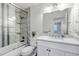 Bathroom featuring a tiled shower, marble countertop vanity, and bright lighting at 45 Pierce St, Lakewood, CO 80226