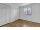 Bedroom with laminate floors, white trim, a window with blinds, and two closets at 45 Pierce St, Lakewood, CO 80226