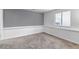 Simple bedroom with gray accent wall, carpet, and natural light at 45 Pierce St, Lakewood, CO 80226
