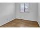 Bedroom with laminate floors, white trim, and a well-lit window with bright light at 45 Pierce St, Lakewood, CO 80226