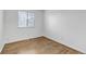 Bright bedroom with laminate floors, white trim, and a well-lit window with bright light at 45 Pierce St, Lakewood, CO 80226
