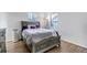 Cozy bedroom featuring a large bed, hardwood floors, and plenty of natural light at 45 Pierce St, Lakewood, CO 80226