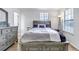 Comfortable bedroom with neutral paint, ensuite bath, and large windows at 45 Pierce St, Lakewood, CO 80226
