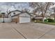 Home's front exterior with a brick accent, driveway, garage, and lawn at 45 Pierce St, Lakewood, CO 80226