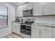 Close-up of the kitchen features modern stainless steel appliances and white cabinets at 45 Pierce St, Lakewood, CO 80226