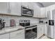 Well-equipped kitchen with stainless steel appliances, granite countertops, and ample cabinet space for storage at 45 Pierce St, Lakewood, CO 80226