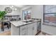 Modern kitchen with dining area and an island with stainless steel appliances and fixtures at 45 Pierce St, Lakewood, CO 80226