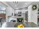 Eat-in kitchen with stainless steel appliances, an island with seating, and modern finishes at 45 Pierce St, Lakewood, CO 80226