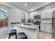 Bright kitchen with white cabinets, granite countertops, and stainless-steel appliances at 45 Pierce St, Lakewood, CO 80226
