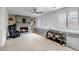 Comfortable living room with a brick fireplace, ceiling fan, and ample natural light at 45 Pierce St, Lakewood, CO 80226