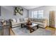 Bright living room with sectional couch, decorative art and lots of natural light at 45 Pierce St, Lakewood, CO 80226