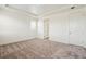 Spacious bedroom features neutral carpet and white trim with large window at 1842 Chaffee Crest Dr, Berthoud, CO 80513