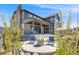 Charming back patio with stone accents, a cozy fire pit, and comfortable seating, perfect for outdoor living at 6677 Crossbridge Cir, Castle Rock, CO 80108