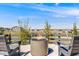 Relaxing backyard view with seating around a modern fire pit overlooking green spaces and a distant community at 6677 Crossbridge Cir, Castle Rock, CO 80108