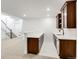Finished basement bar with dark wood cabinets, white countertops and open stairs at 6677 Crossbridge Cir, Castle Rock, CO 80108