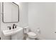 Contemporary powder room with a pedestal sink, modern fixtures, and neutral decor at 6677 Crossbridge Cir, Castle Rock, CO 80108