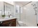 Bright bathroom with a glass-enclosed shower, a vanity with dark wood cabinets, and neutral finishes at 6677 Crossbridge Cir, Castle Rock, CO 80108
