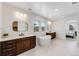 Bright bathroom featuring double vanities, a soaking tub, and natural light from the window at 6677 Crossbridge Cir, Castle Rock, CO 80108