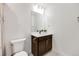 Bright bathroom featuring a vanity with dark cabinets, white countertops, toilet and mirror at 6677 Crossbridge Cir, Castle Rock, CO 80108