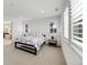 Bright bedroom featuring shuttered windows, carpeted flooring, and neutral decor at 6677 Crossbridge Cir, Castle Rock, CO 80108