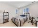 Bright bedroom with a bed, desk, and windows that offer plenty of natural light at 6677 Crossbridge Cir, Castle Rock, CO 80108