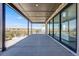 Expansive covered patio boasts scenic views with sleek design, and seamless indoor-outdoor transition at 6677 Crossbridge Cir, Castle Rock, CO 80108