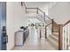 Bright foyer with wooden floors, high ceilings, a view of the staircase, and custom decor at 6677 Crossbridge Cir, Castle Rock, CO 80108