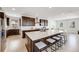 Modern kitchen featuring a large island with seating, stainless steel appliances, dark wood cabinetry, and hardwood flooring at 6677 Crossbridge Cir, Castle Rock, CO 80108